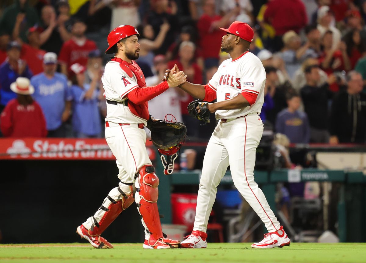 Los Angeles Angels catcher #35 Travis d'Arnaud and pitcher #54 Hector Neris celebrate a win against the Boston Red Sox on June 23, 2025 in Anaheim, CA.