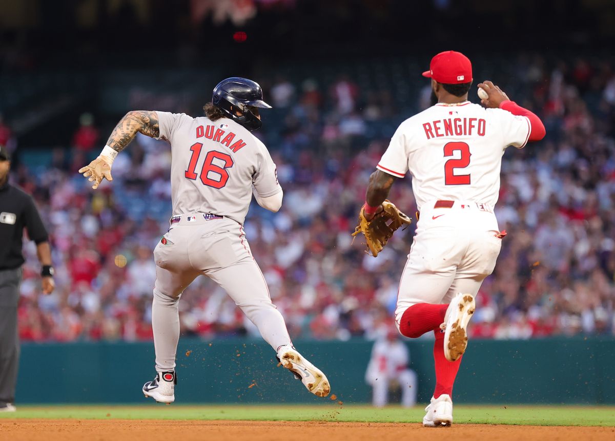 Boston Red Sox outfielder #16 Jarren Duran tries to avoid the tag by Los Angeles Angels infielder #2 Luis Renfgifo during an MLB game against the Los Angeles Angels on June 23, 2025 in Anaheim, CA.