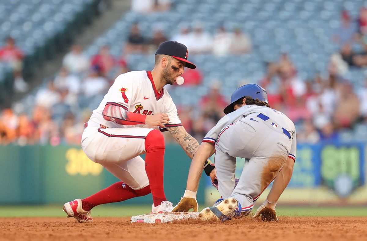 #9 Zach Neto of the Los Angeles Angels attempts to make a tag at second base during an MLB game against the Texas Rangers on July 9, 2025 in Anaheim, CA.