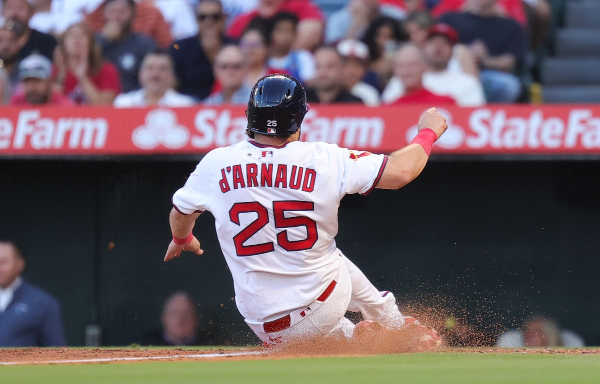 #25 Travis d'Arnaud of the Los Angeles Angels slides home against the Texas Rangers on July 9, 2025 in Anaheim, CA.