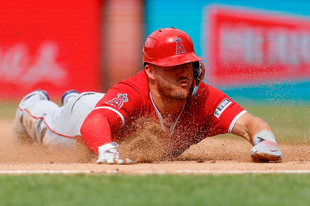 Mike Trout #27 of the Los Angeles Angels slides into third base during a game against the Philadelphia Phillies at Citizens Bank Park on July 19, 2025, in Philadelphia, Pennsylvania.