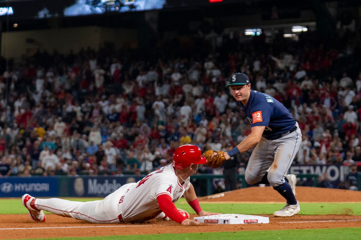 Los Angeles Angels infielder Kevin Newman (10) slides to third base during the MLB game against the Seattle Mariners, Friday July 25th, 2025 in Anaheim, California. 