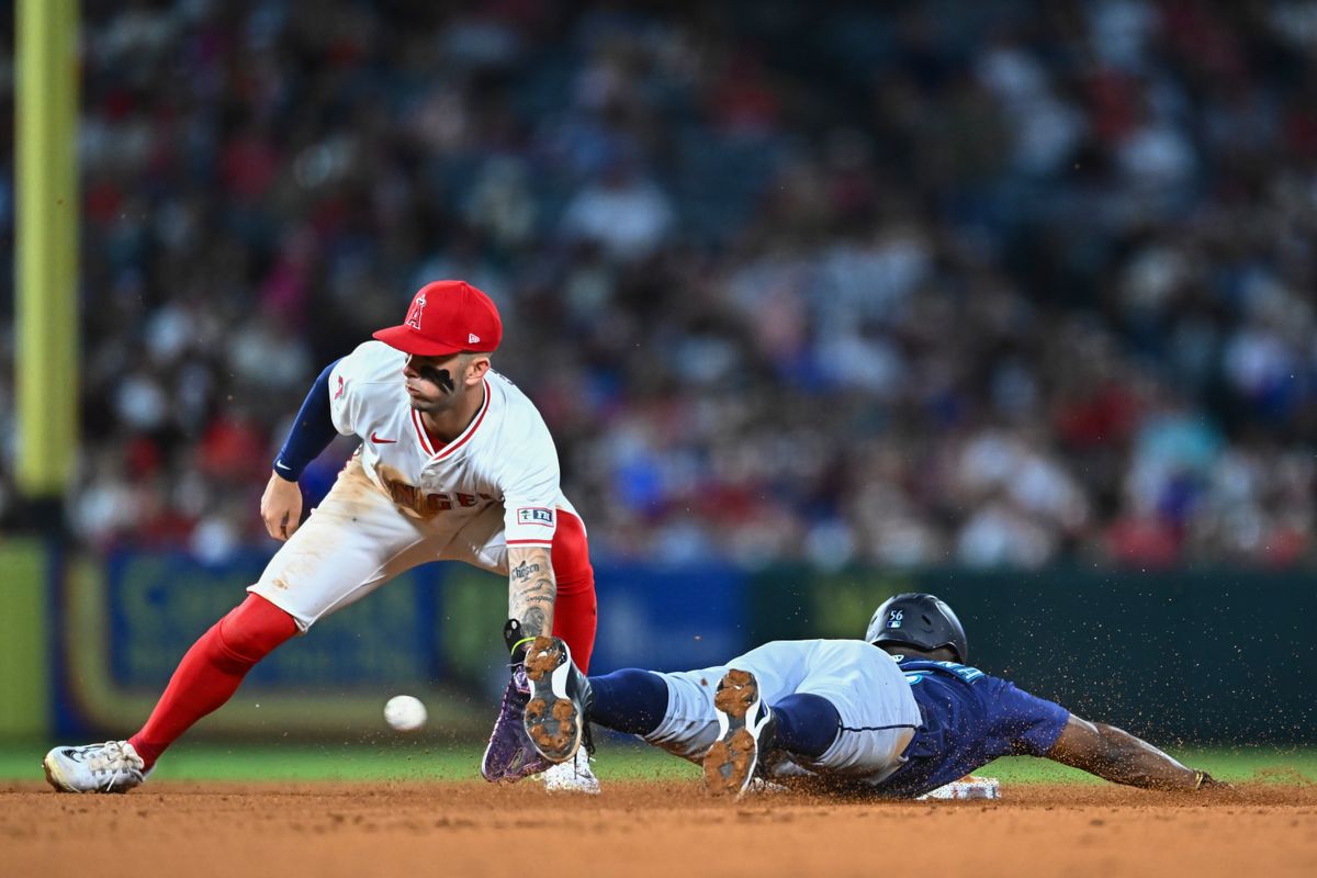 Seattle Mariners outfielder Randy Arozarena (56) steals second base against Los Angeles Angels shortstop Zach Neto (9) during the sixth inning at Angel Stadium.