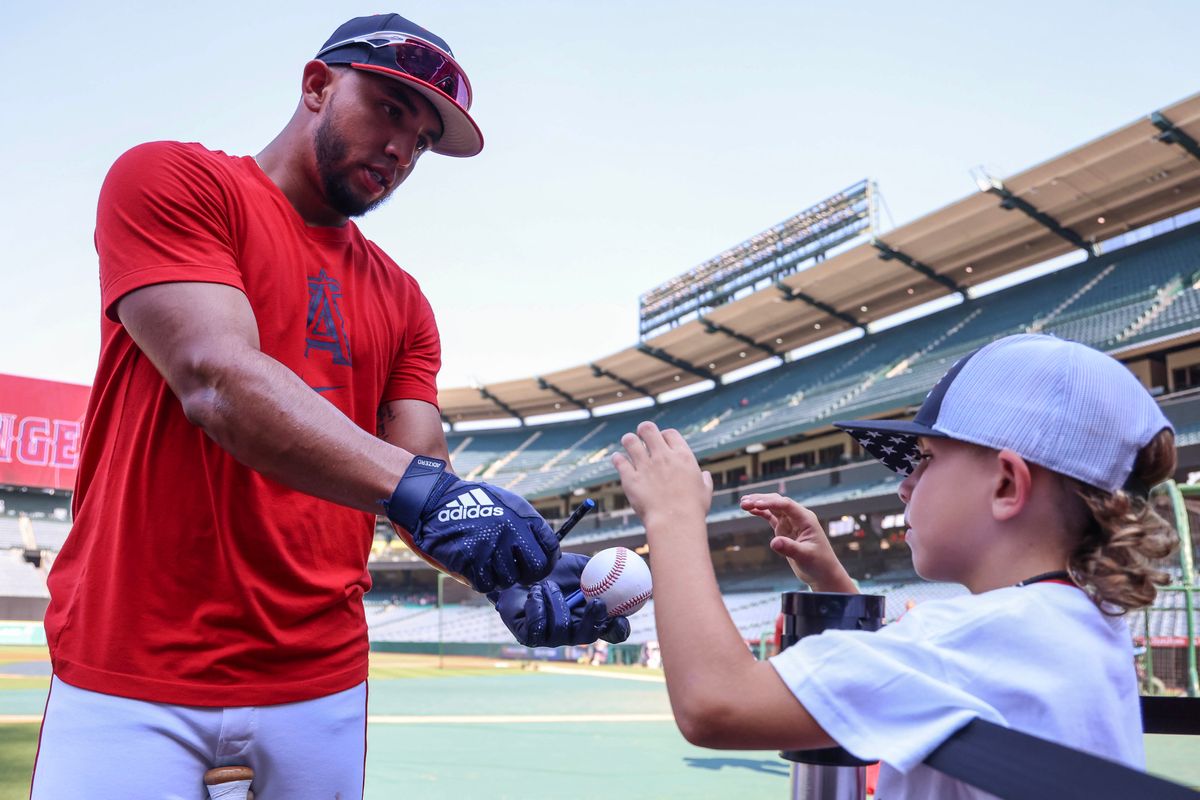Los Angeles Angels infielder Oswald Peraza (10) signs a ball for a young fan before the MLB game against the Tampa Bay Rays Tuesday August 5th, 2025 at Angel's Stadium in Anaheim, Calif.