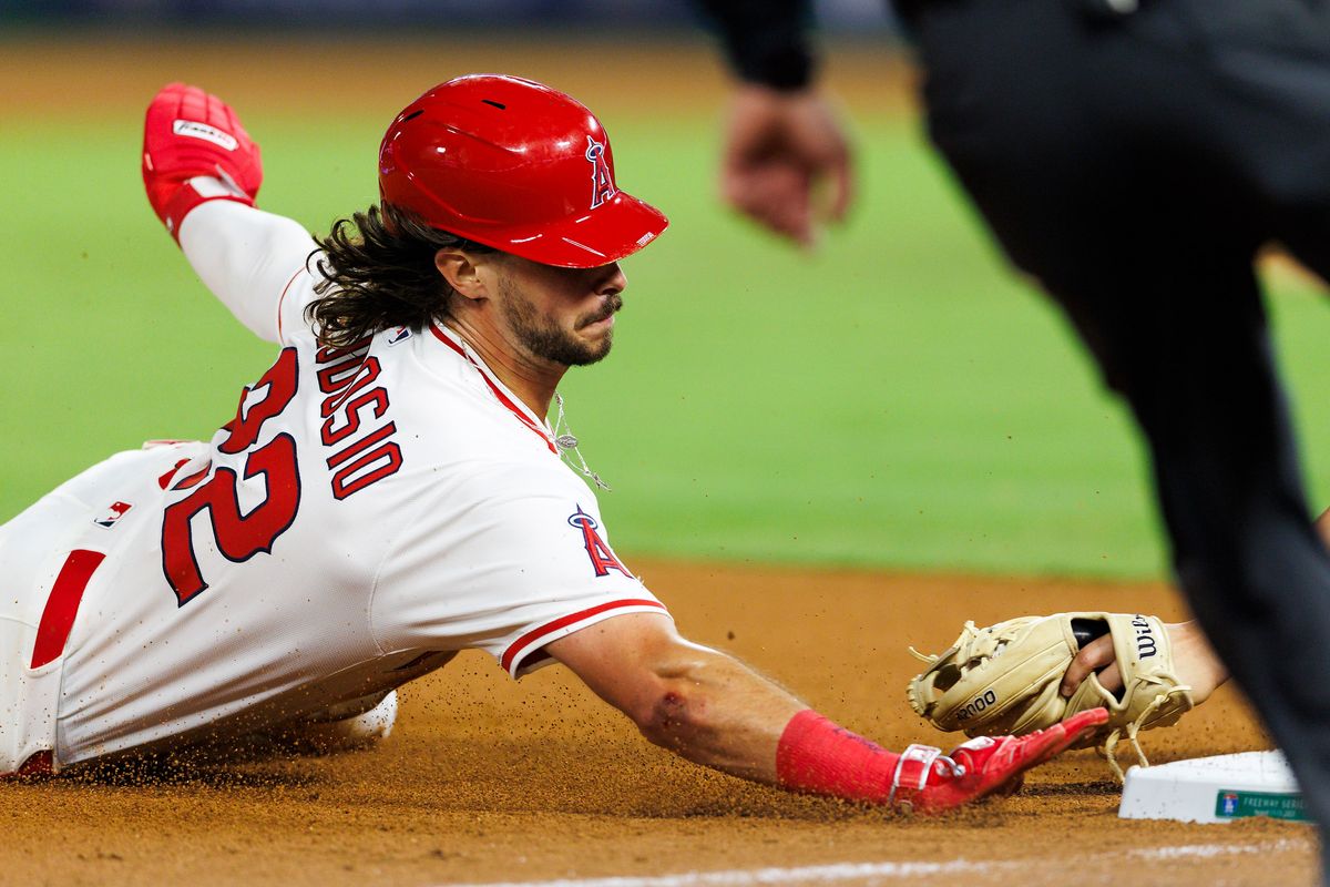 Bryce Teodosio #22 of the Los Angeles Angels is tagged out at third base during the game against the Los Angeles Angels at Angel Stadium of Anaheim on August 13, 2025 in Anaheim, California.