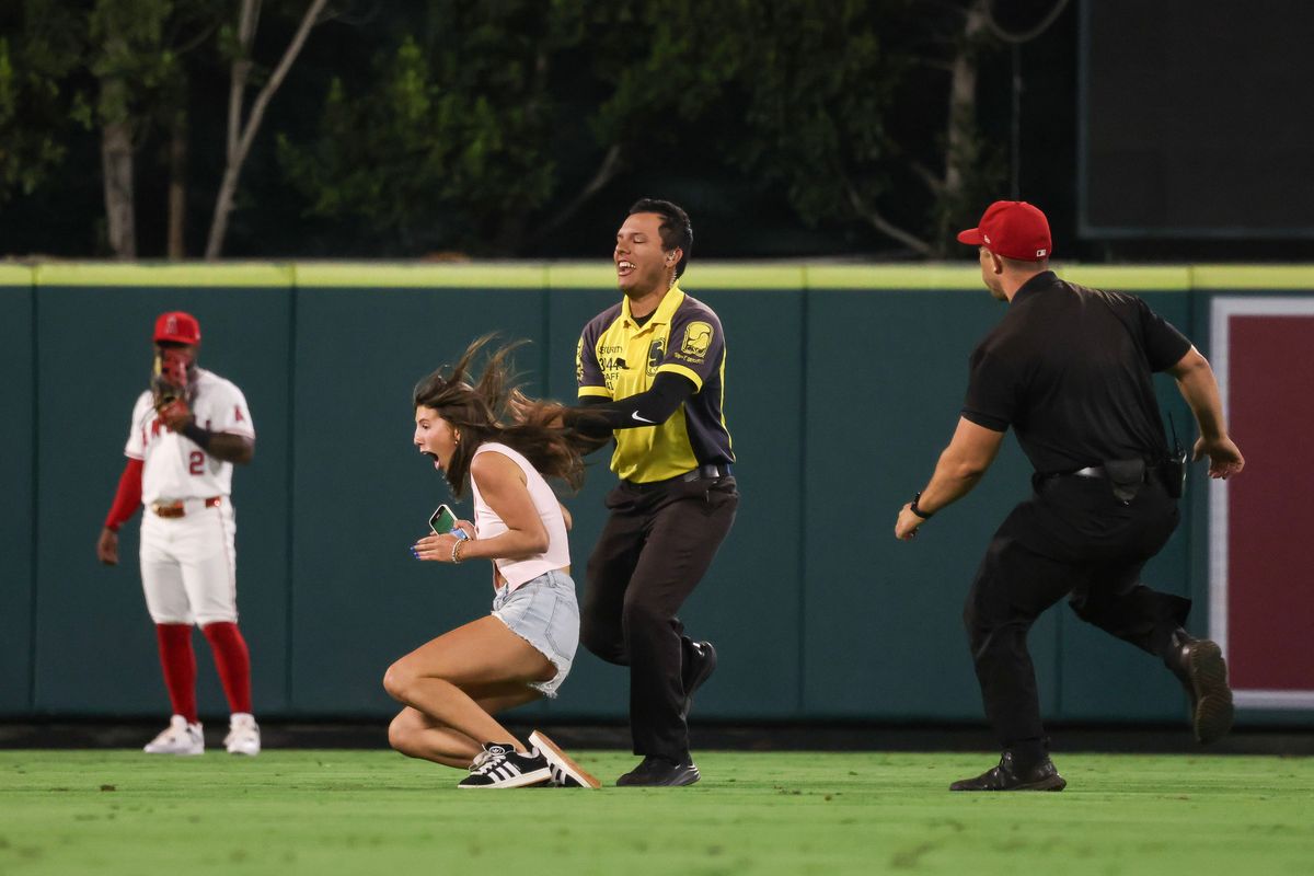Fan gets tackled after running onto the field at the Los Angeles Angels MLB game against the Cincinnati Reds Monday August 18th, 2025 at Angel's Stadium in Anaheim, Calif.