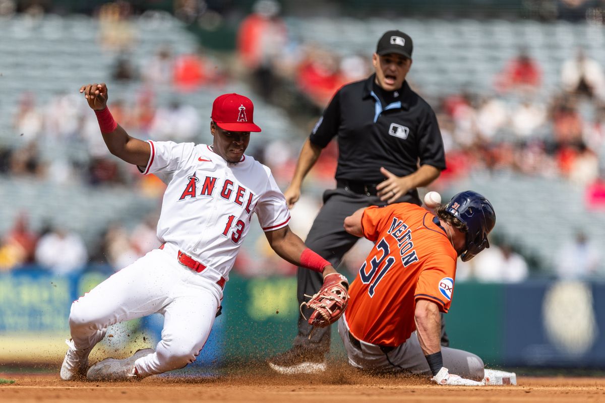 Los Angeles Angels shortstop Denzer Guzman (13) mishandles the ball while tagging the incoming runner from first base during the MLB game against the Houston Astros on Sunday, September 28, 2025, at Angel Stadium in Anaheim, Calif.