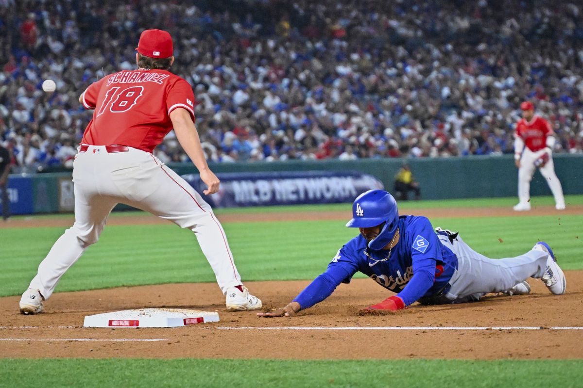 The Los Angeles Dodgers short stop Mookie Betts (50) slides into first during a Spring Training Game against The Los Angeles Angels, March 22nd, 2026 in Anaheim, California.