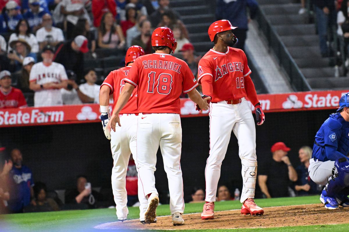 The Los Angeles Angels center fielder Mike Trout (27) first baseman Nolan Schanuel (18) and center fielder Jorge Soler (12) celebrate three runs scored during a Spring Training Game against The Los Angeles Dodgers, March 22nd, 2026 in Anaheim, California.
