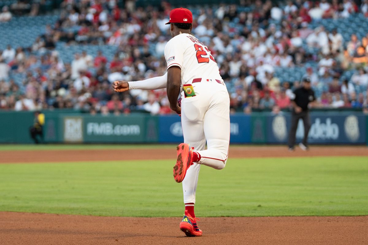 Los Angeles Angels SS Denzer Guzman (23) catches a grounder and throws the runner out at first base during an MLB game against the Tampa Bay Rays at Angel Stadium on June 13, 2026, in Anaheim, California.