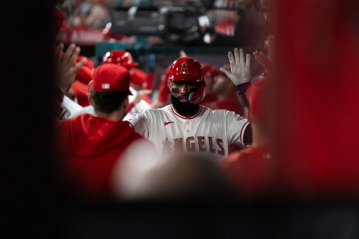 Los Angeles Angels Jo Adell (7) celebrates with his teammates after scoring a run during an MLB game against the Tampa Bay Rays at Angel Stadium on June 13, 2026, in Anaheim, California.