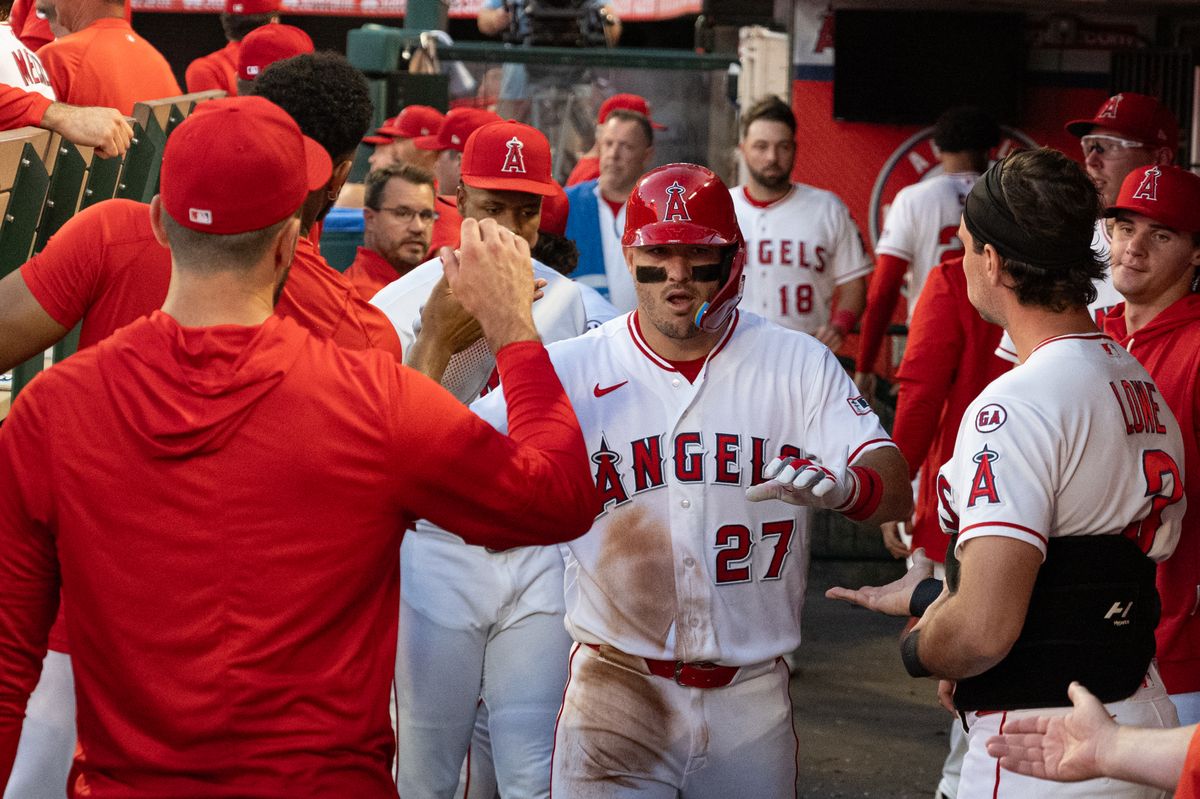 Los Angeles Angels center outfielder Mike Trout (27) gets high-fives at the dugout after scoring during a game between the Texas Rangers and the Los Angeles Angels on Tuesday, August 11, 2026 at Angels Stadium in Anaheim Calif. Los Angeles Angels center outfielder Mike Trout (27) gets high-fives at the dugout after scoring during a game between the Texas Rangers and the Los Angeles Angels on Tuesday, August 11, 2026 at Angels Stadium in Anaheim Calif.