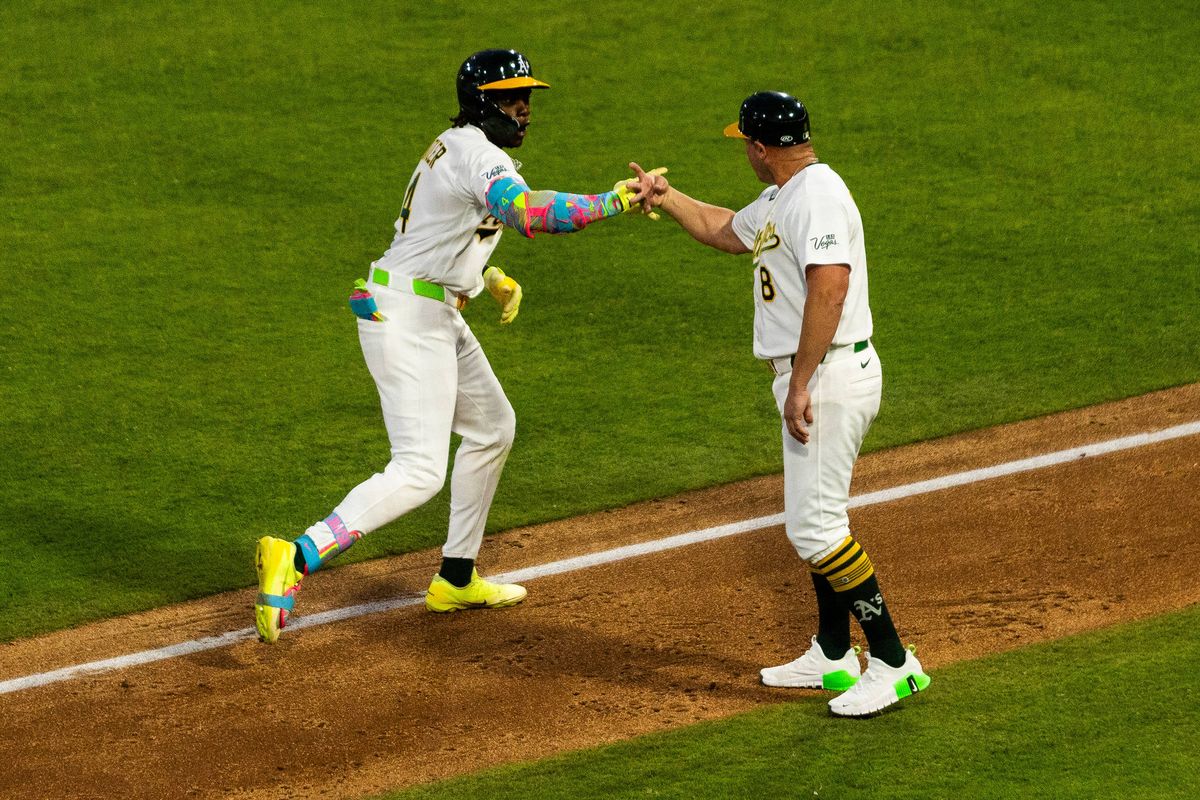 Athletics outfielder Lawrence Butler (4) high-fives a coach as he rounds the bases after hitting a home run during a MLB game between the The Athletics and the Milwaukee Brewers, Wednesday June 10, 2026 in Las Vegas, Nev. Athletics outfielder Lawrence Butler (4) high-fives a coach as he rounds the bases after hitting a home run during a MLB game between the The Athletics and the Milwaukee Brewers, Wednesday June 10, 2026 in Las Vegas, Nev.