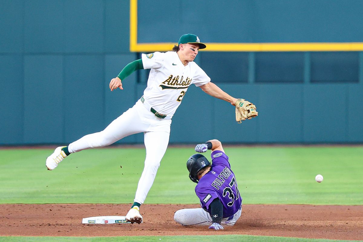 Colorado Rockies DH Braxton Fulford (37) slides under Athletics 2B Zack Gelof (20) after stealing the base during an MLB game on Friday June 12, 2026, at the Las Vegas Ballpark in Las Vegas, Nevada.