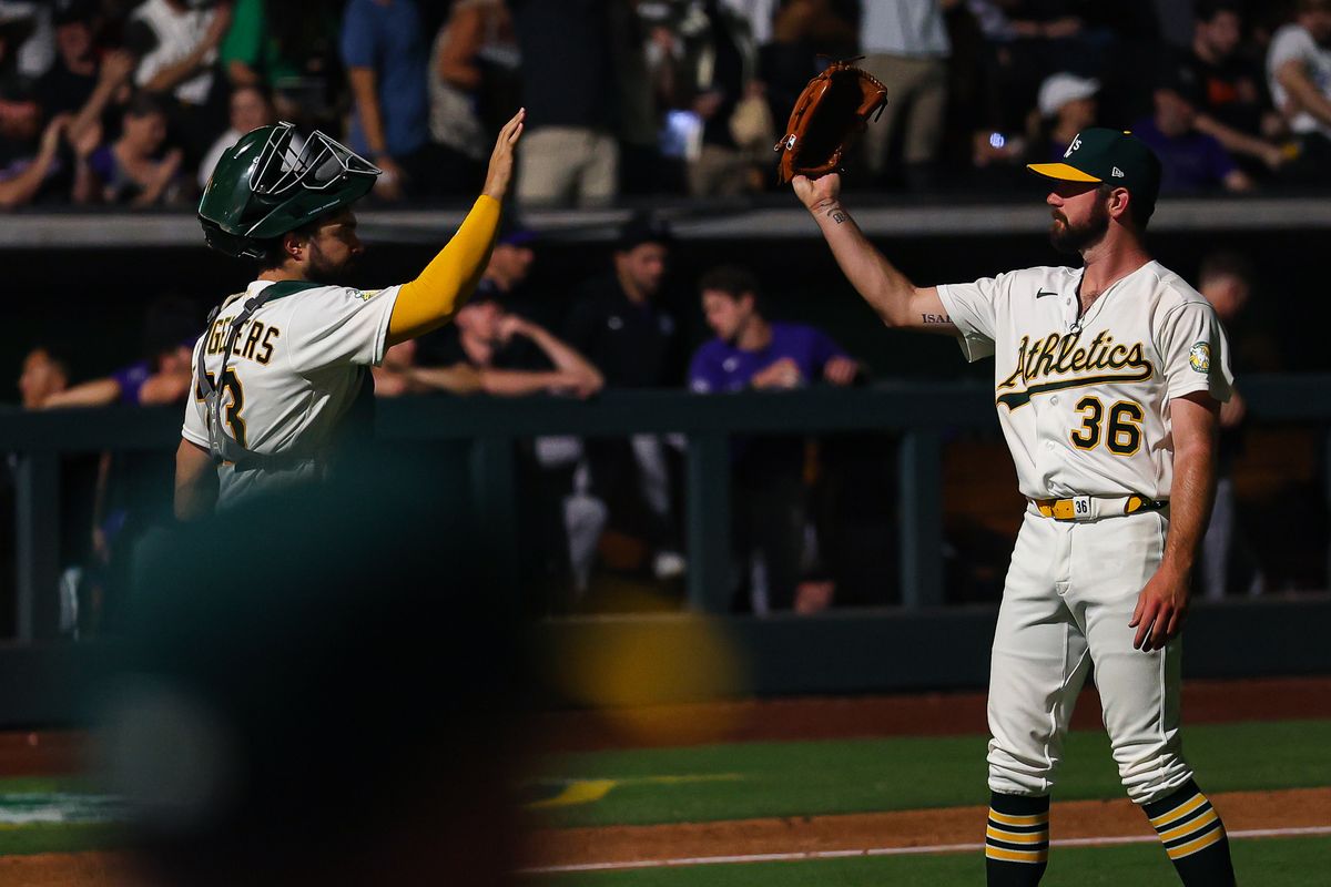 Athletics C Shea Langeliers (23) and LHP Hogan Harris (36) high-five after defeating the Colorado Rockies on Friday June 12, 2026, at the Las Vegas Ballpark in Las Vegas, Nevada.