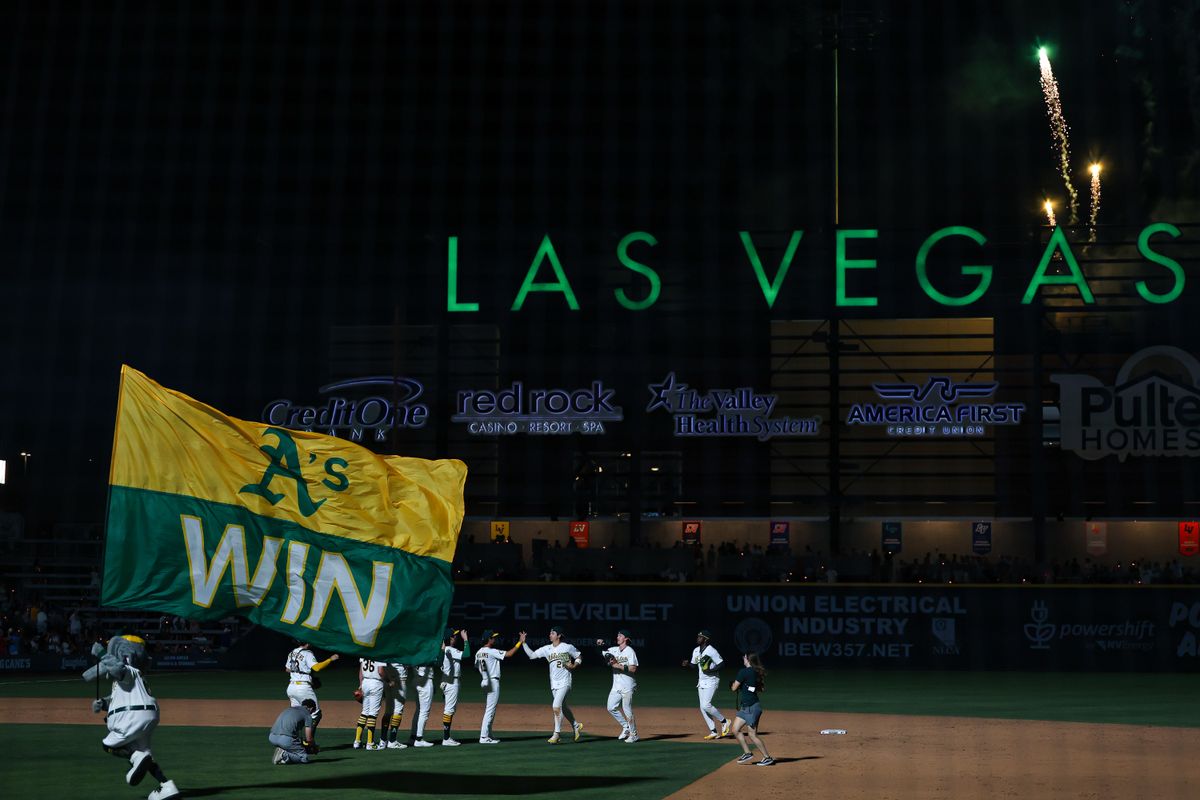 Athletics mascot Stomper carries the “A’s Win” flag across the field after the Athletics defeated the Colorado Rockies, 6-4, on Friday June 12, 2026, at the Las Vegas Ballpark in Las Vegas, Nevada.