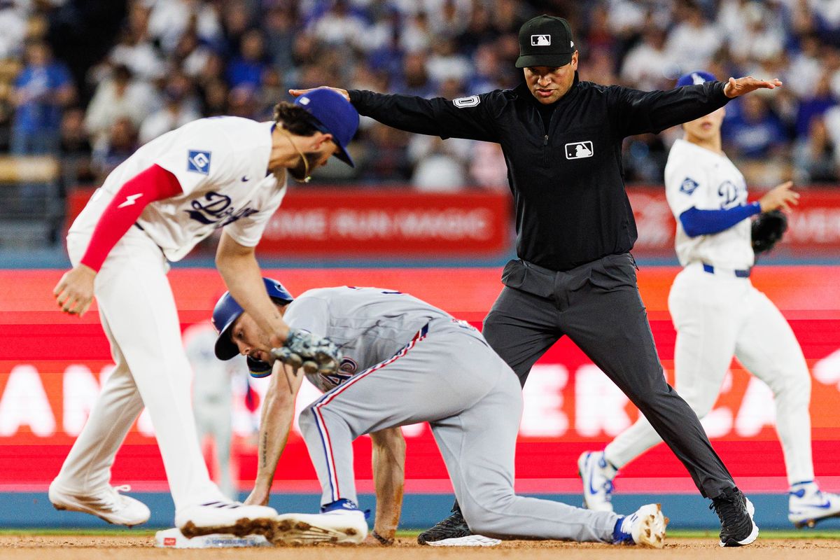 Evan Carter #32 of the Texas Rangers steals second base during an MLB game against the Los Angeles Dodgers at Dodger Stadium on April 10, 2026 in Los Angeles, California.
