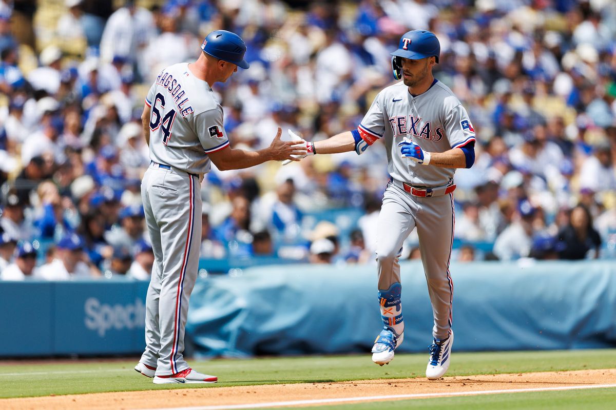 Evan Carter #32 of the Texas Rangers celebrates his home run during the game against the Los Angeles Dodgers at Dodger Stadium on April 12, 2026 in Los Angeles, California.