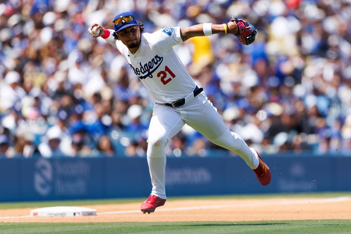 Santiago Espinal #21 of the Los Angeles Dodgers throws during the game against the Chicago Cubs at Dodger Stadium on April 26, 2026 in Los Angeles, California. 