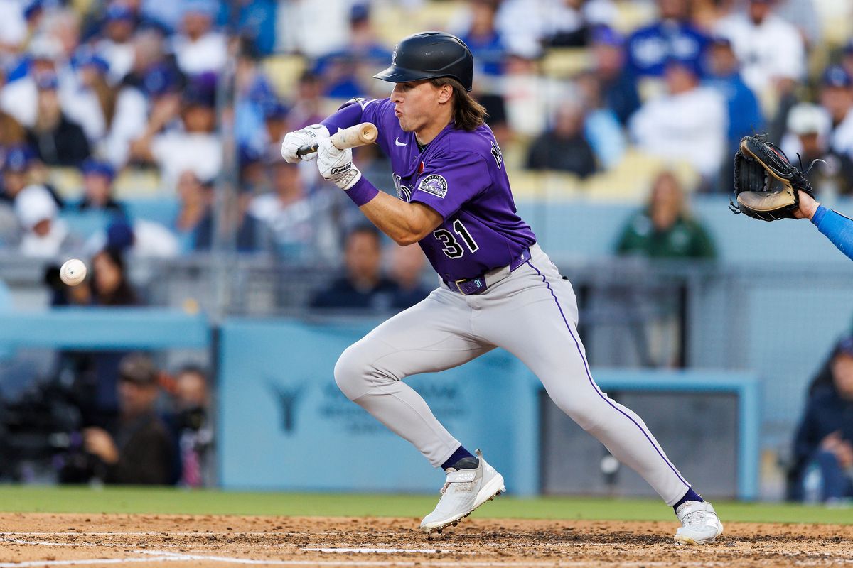 Jake McCarthy #31 of the Colorado Rockies bunts during the game against the Los Angeles Dodgers at Dodger Stadium on May 25, 2026 in Los Angeles, California. Jake McCarthy #31 of the Colorado Rockies bunts during the game against the Los Angeles Dodgers at Dodger Stadium on May 25, 2026 in Los Angeles, California.