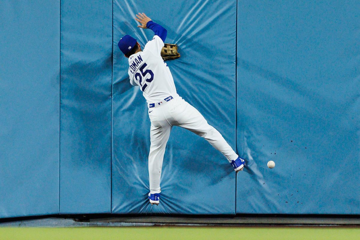 Tommy Edman #25 of the Los Angeles Dodgers runs into the wall during the game against the Washington Nationals at Dodger Stadium on September 6, 2026 in Los Angeles, California. Tommy Edman #25 of the Los Angeles Dodgers runs into the wall during the game against the Washington Nationals at Dodger Stadium on September 6, 2026 in Los Angeles, California.