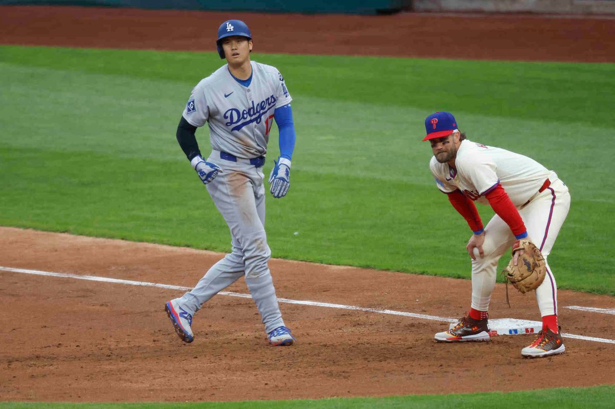 Shohei Ohtani #17 of the Los Angeles Dodgers takes a lead off first base being guarded by Bryce Harper #3 of the Philadelphia Phillies during a game at Citizens Bank Park on April 5, 2025 in Philadelphia, Pennsylvania.