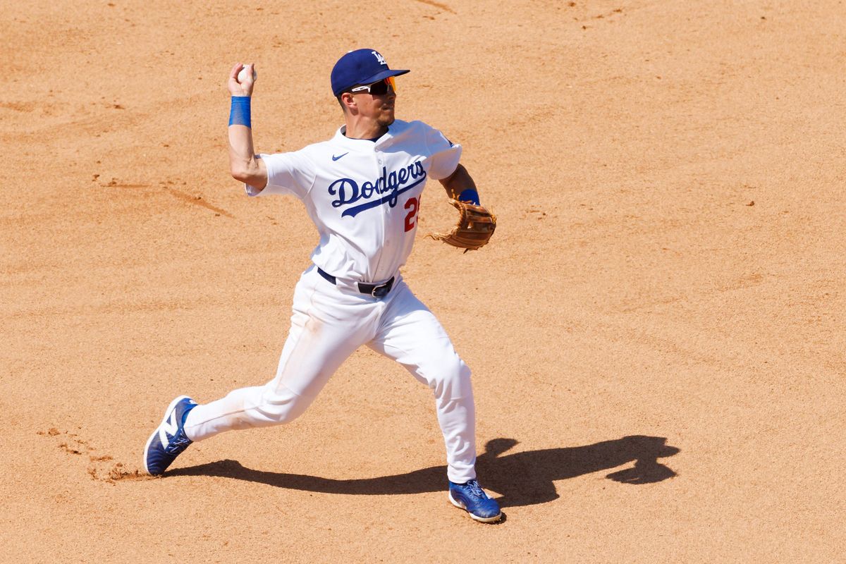 Tommy Edman #25 of the Los Angeles Dodgers throws during the game against the Milwaukee Brewers at Dodger Stadium on July 20, 2025 in Los Angeles, California. 