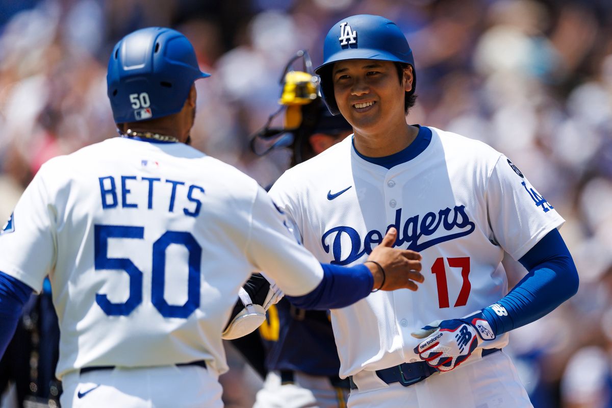 Shohei Ohtani #17 of the Los Angeles Dodgers celebrates his home run with Mookie Betts #50 of the Los Angeles Dodgers during the game against the Milwaukee Brewers at Dodger Stadium on July 20, 2025 in Los Angeles, California.
