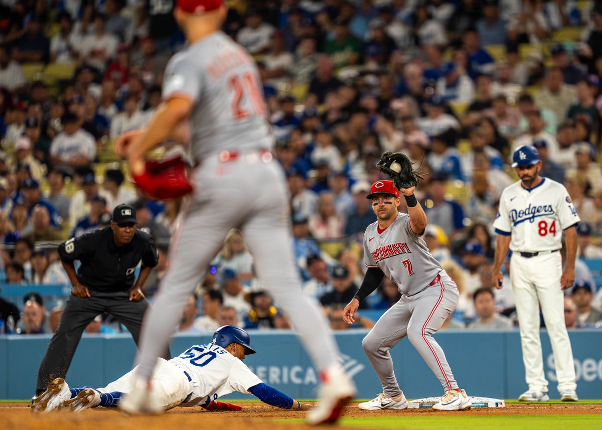 Los Angeles Dodgers infielder, Mookie Betts 50, dives for first base during an MLB baseball game against the Cincinnati Reds on August 26, 2025 in Los Angeles, CA.