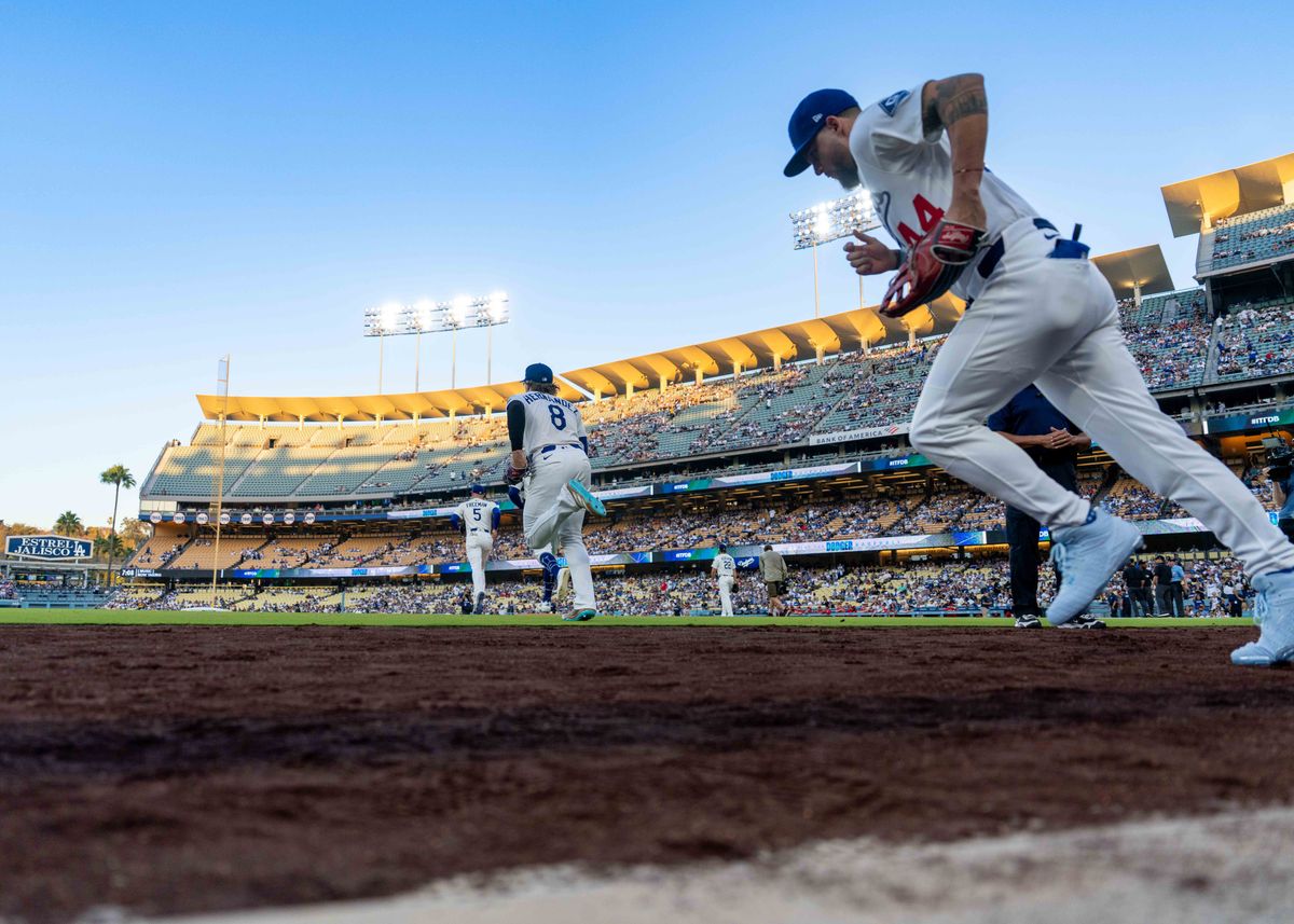 Los Angeles Dodgers outfielder, Andy Pages 44, enters the field with teammates during an MLB baseball game against the Cincinnati Reds on August 26, 2025 in Los Angeles, CA.