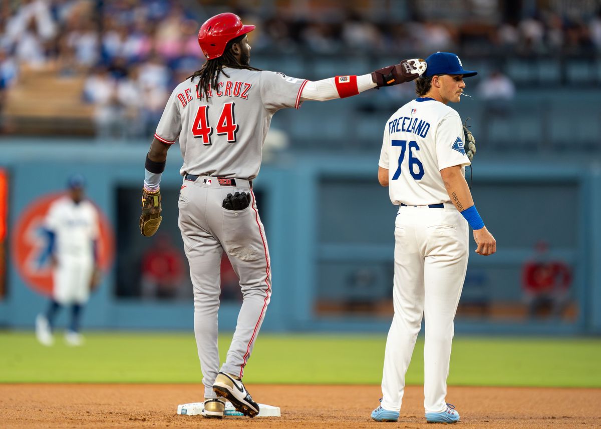 Los Angeles Dodgers infielder, Alex Freeland 76, gets tapped on the head by opponent Elly De La Cruz (44) during an MLB baseball game against the Cincinnati Reds on August 26, 2025 in Los Angeles, CA.
