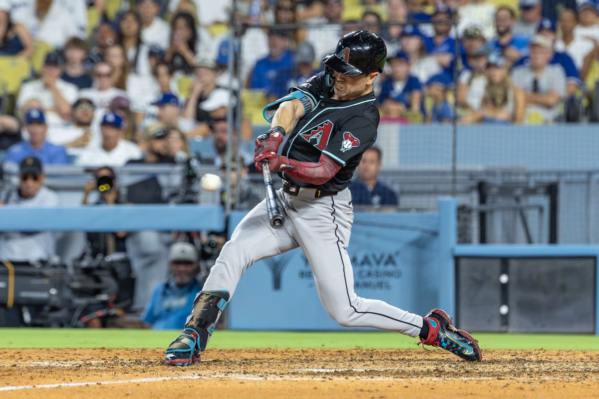 Corbin Carroll #7 of the Arizona Diamondbacks hits a double during an MLB game against the Los Angeles Dodgers at Dodger Stadium on August 30, 2025 in Los Angeles, California.
