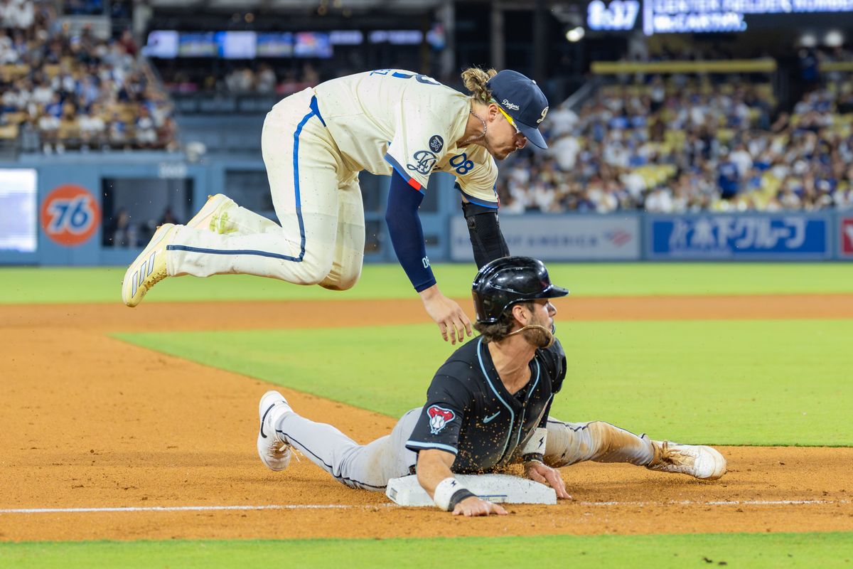 Enrique Hernández #8 of the Los Angeles Dodgers attempts a tag at third base during an MLB game against the Arizona Diamondbacks at Dodger Stadium on August 30, 2025 in Los Angeles, California.