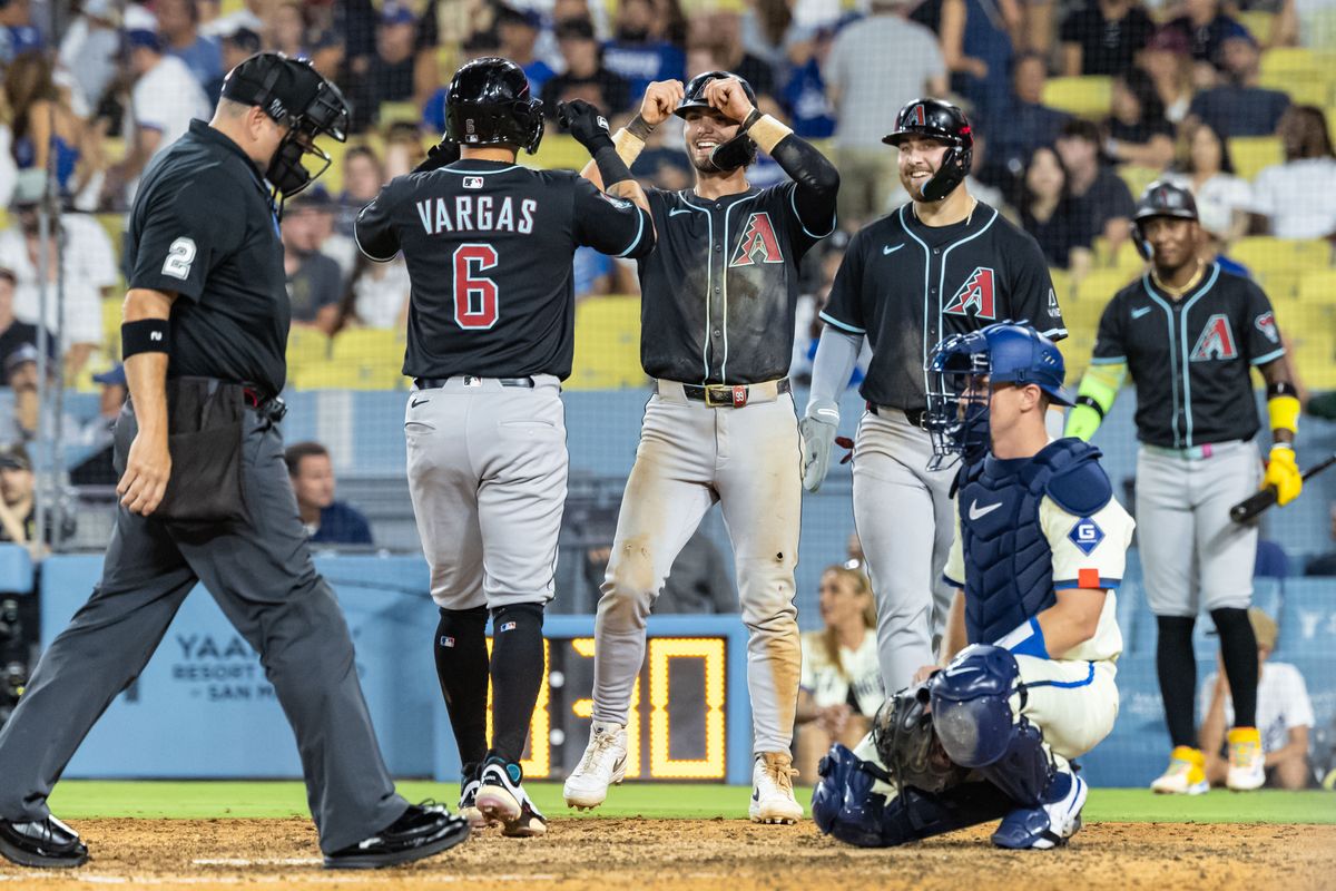 The Arizona Diamondbacks celebrate a three-run home run by Ildemaro Vargas #6 of the Arizona Diamondbacks during an MLB game against the Los Angeles Dodgers at Dodger Stadium on August 30, 2025 in Los Angeles, California.