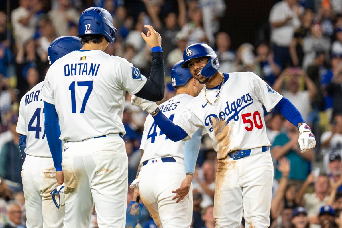 Los Angeles Dodgers infielder Mookie Betts (50) celebrates his grand slam at home plate with his teammates during an MLB baseball game against the Colorado Rockies, Wednesday September 10th, 2025 in Los Angeles, California. Los Angeles Dodgers infielder Mookie Betts (50) celebrates his grand slam at home plate with his teammates during an MLB baseball game against the Colorado Rockies, Wednesday September 10th, 2025 in Los Angeles, California.