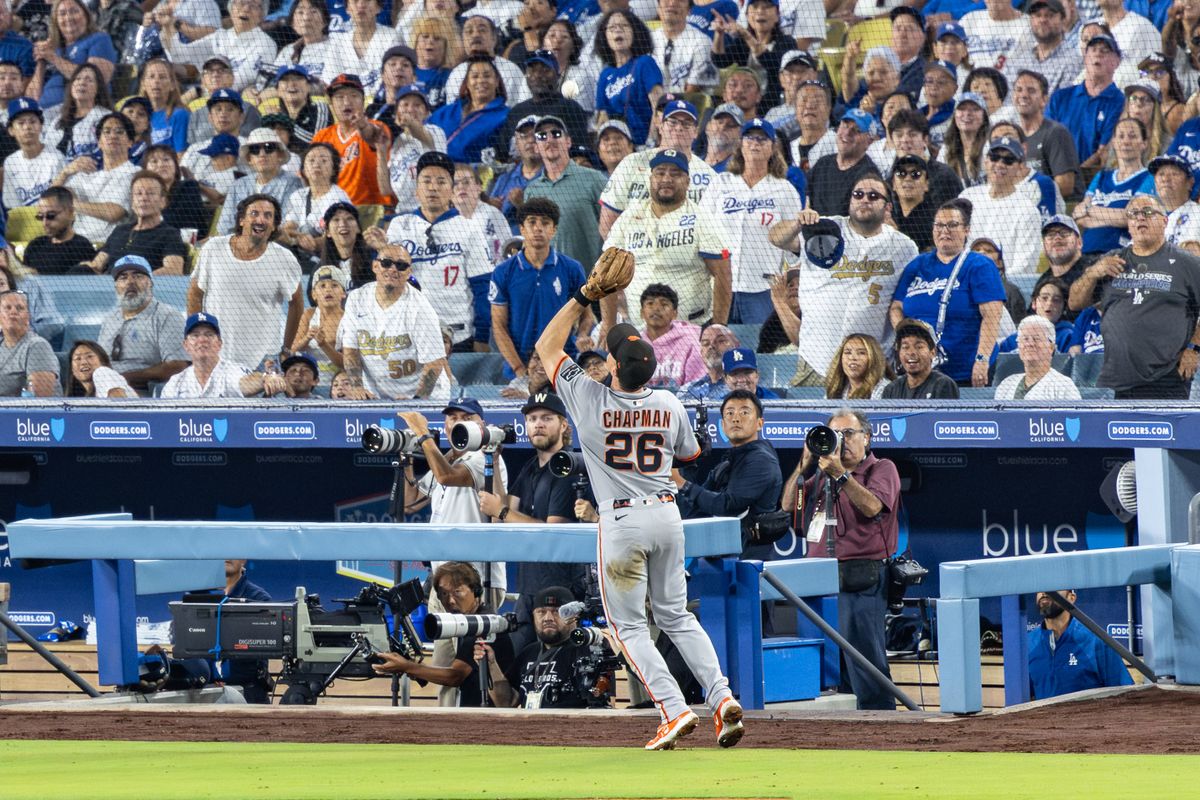 Matt Chapman #26 of the San Francisco Giants makes a catch in foul territory during an MLB game against the Los Angeles Dodgers at Dodger Stadium on September 20, 2025 in Los Angeles, California. Matt Chapman #26 of the San Francisco Giants makes a catch in foul territory during an MLB game against the Los Angeles Dodgers at Dodger Stadium on September 20, 2025 in Los Angeles, California.