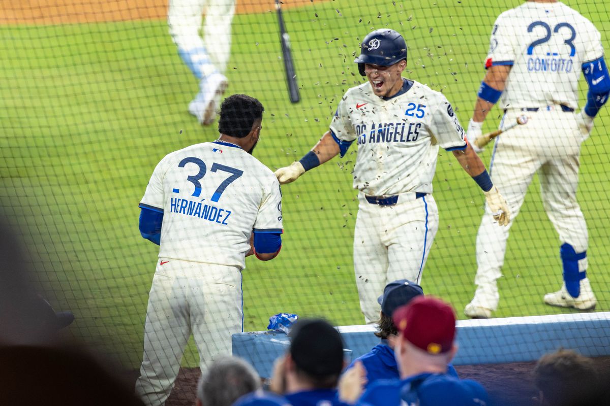 Teoscar Hernández #37 of the Los Angeles Dodgers tosses sunflower seeds on Tommy Edman #25 of the Los Angeles Dodgers to celebrate a home run during an MLB game against the San Francisco Giants at Dodger Stadium on September 20, 2025 in Los Angeles, California. Teoscar Hernández #37 of the Los Angeles Dodgers tosses sunflower seeds on Tommy Edman #25 of the Los Angeles Dodgers to celebrate a home run during an MLB game against the San Francisco Giants at Dodger Stadium on September 20, 2025 in Los Angeles, California.