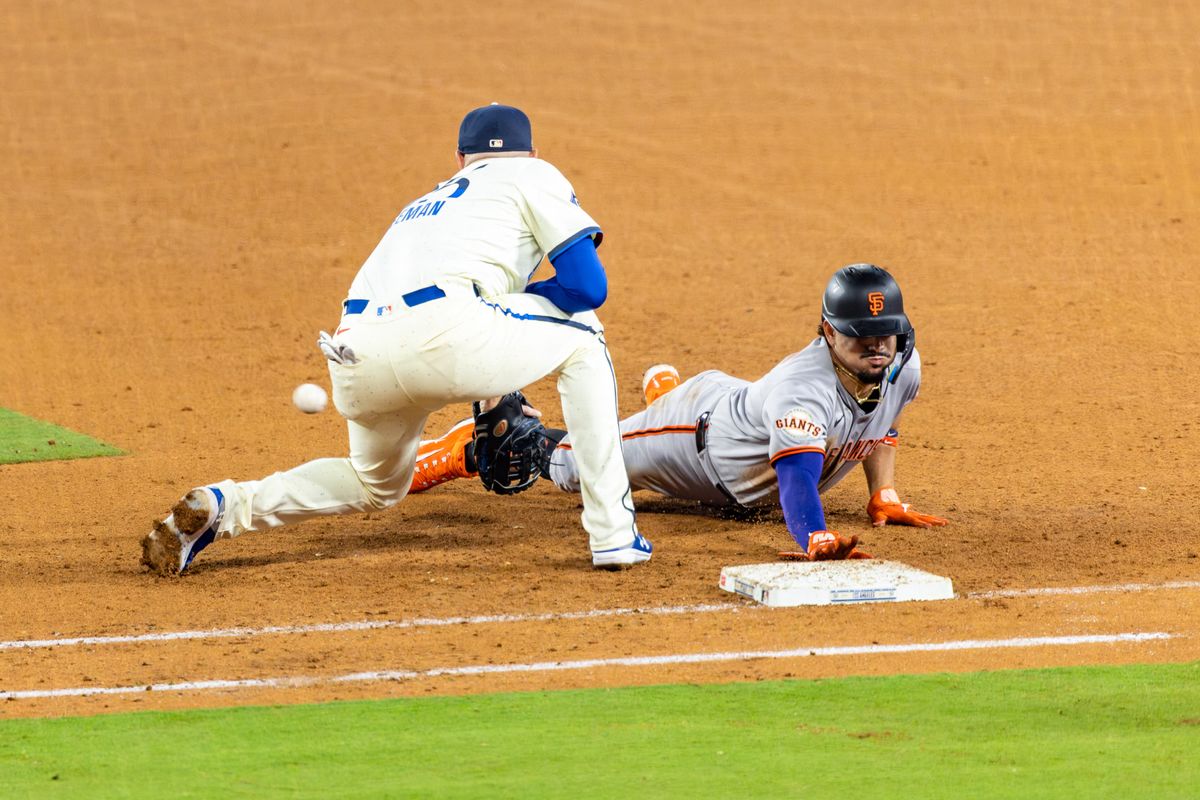 Freddie Freeman #5 of the Los Angeles Dodgers tries to pick off Willy Adames #2 of the San Francisco Giants during an MLB game at Dodger Stadium on September 20, 2025 in Los Angeles, California. Freddie Freeman #5 of the Los Angeles Dodgers tries to pick off Willy Adames #2 of the San Francisco Giants during an MLB game at Dodger Stadium on September 20, 2025 in Los Angeles, California.