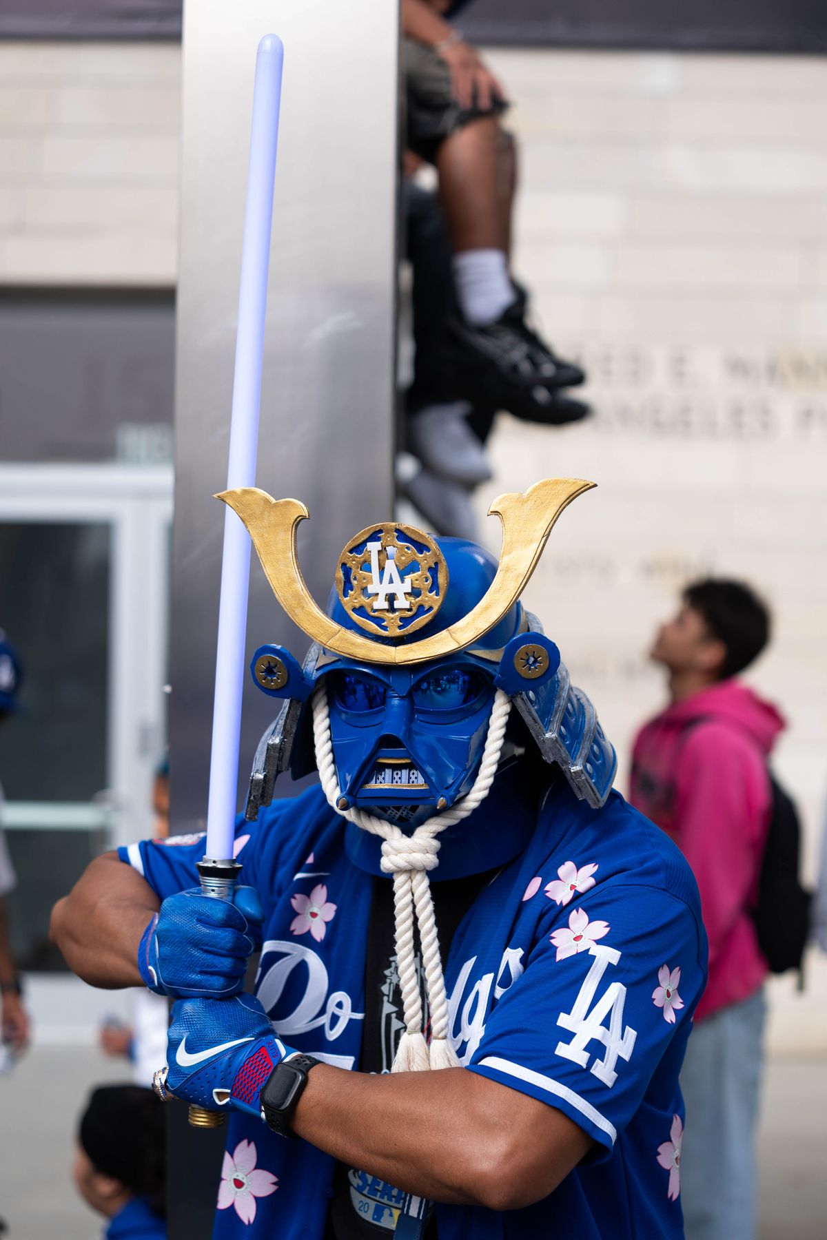 LOS ANGELES, Calif. — Nov. 3, 2025 — A Dodgers fan poses for a photo while wearing a samurai costume during the team’s championship parade on Monday. LOS ANGELES, Calif. — Nov. 3, 2025 — A Dodgers fan poses for a photo while wearing a samurai costume during the team’s championship parade on Monday.