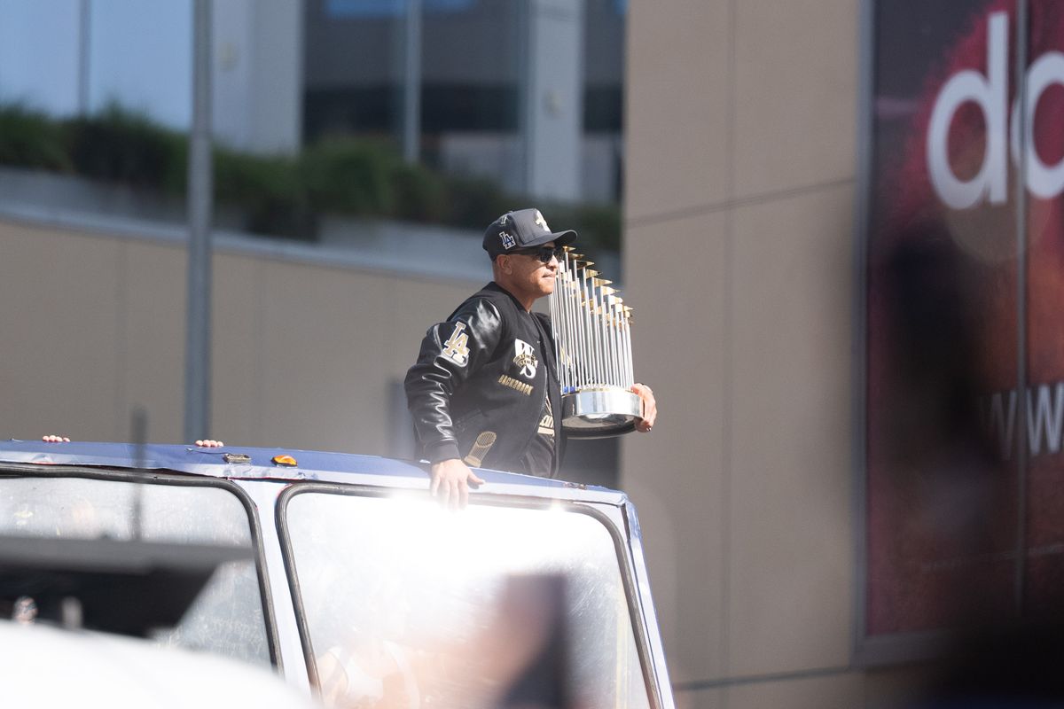 LOS ANGELES, Calif. — Nov. 3, 2025 — Dodgers manager Dave Roberts holds the World Series trophy while passing by during the team’s championship parade on Monday. LOS ANGELES, Calif. — Nov. 3, 2025 — Dodgers manager Dave Roberts holds the World Series trophy while passing by during the team’s championship parade on Monday.
