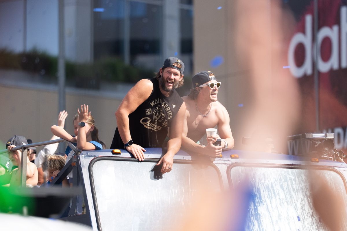 LOS ANGELES, Calif. — Nov. 3, 2025 — Dodgers players Clayton Kershaw and Enrique Hernández smile while riding atop a bus during the team’s championship parade on Monday. LOS ANGELES, Calif. — Nov. 3, 2025 — Dodgers players Clayton Kershaw and Enrique Hernández smile while riding atop a bus during the team’s championship parade on Monday.