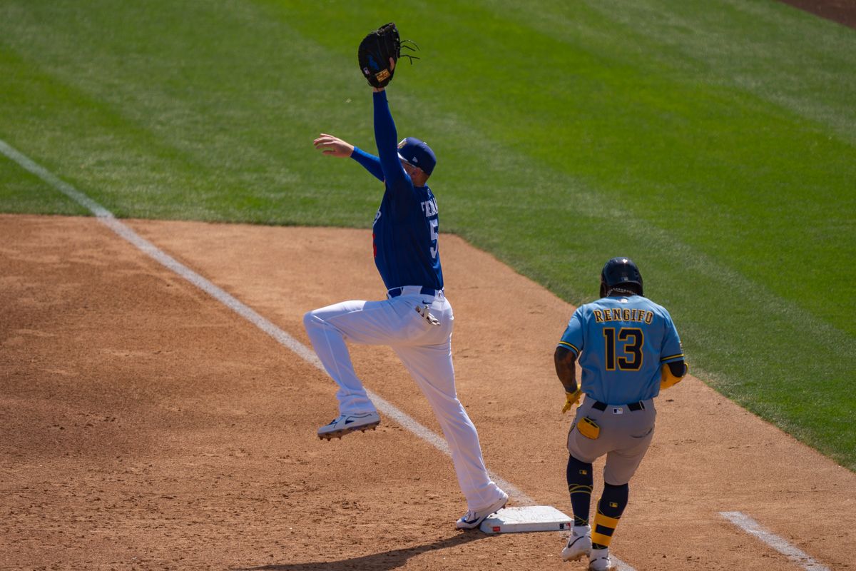Los Angeles Dodgers first baseman Freddie Freeman (5) stretching to catch and tag first base for an out during an MLB spring training baseball game against the Milwaukee Brewers on March 16th, 2026 in Glendale, AZ.