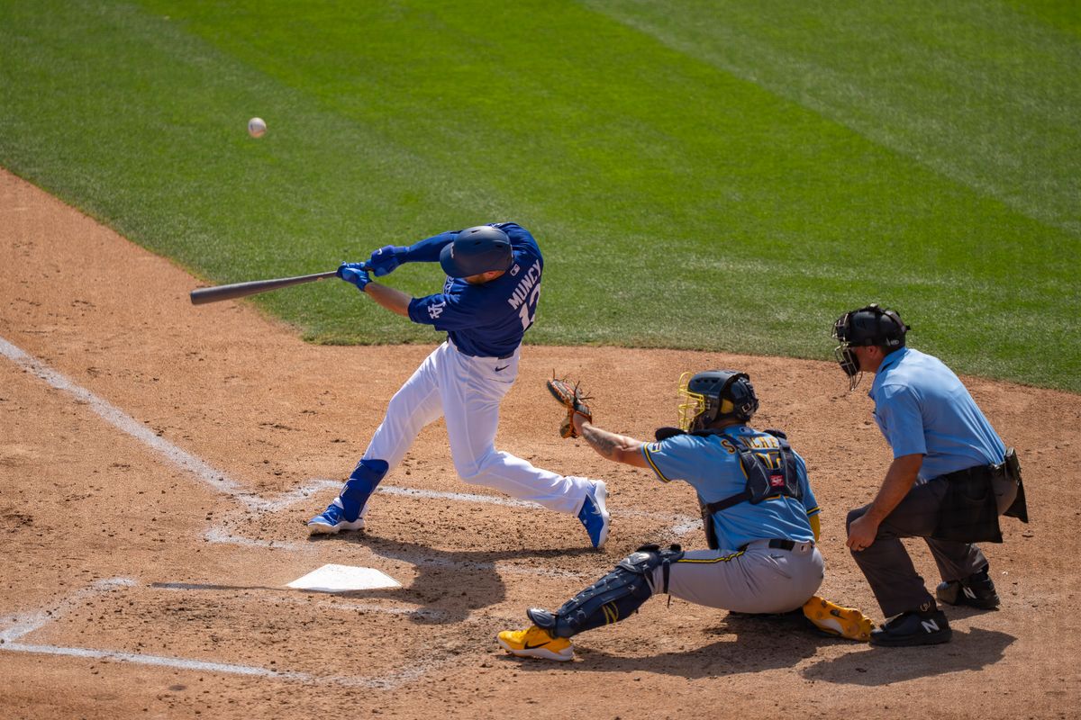 Los Angeles Dodgers third baseman Max Muncy (13) hitting a homerun during an MLB spring training baseball game against the Milwaukee Brewers on March 16th, 2026 in Glendale, AZ.