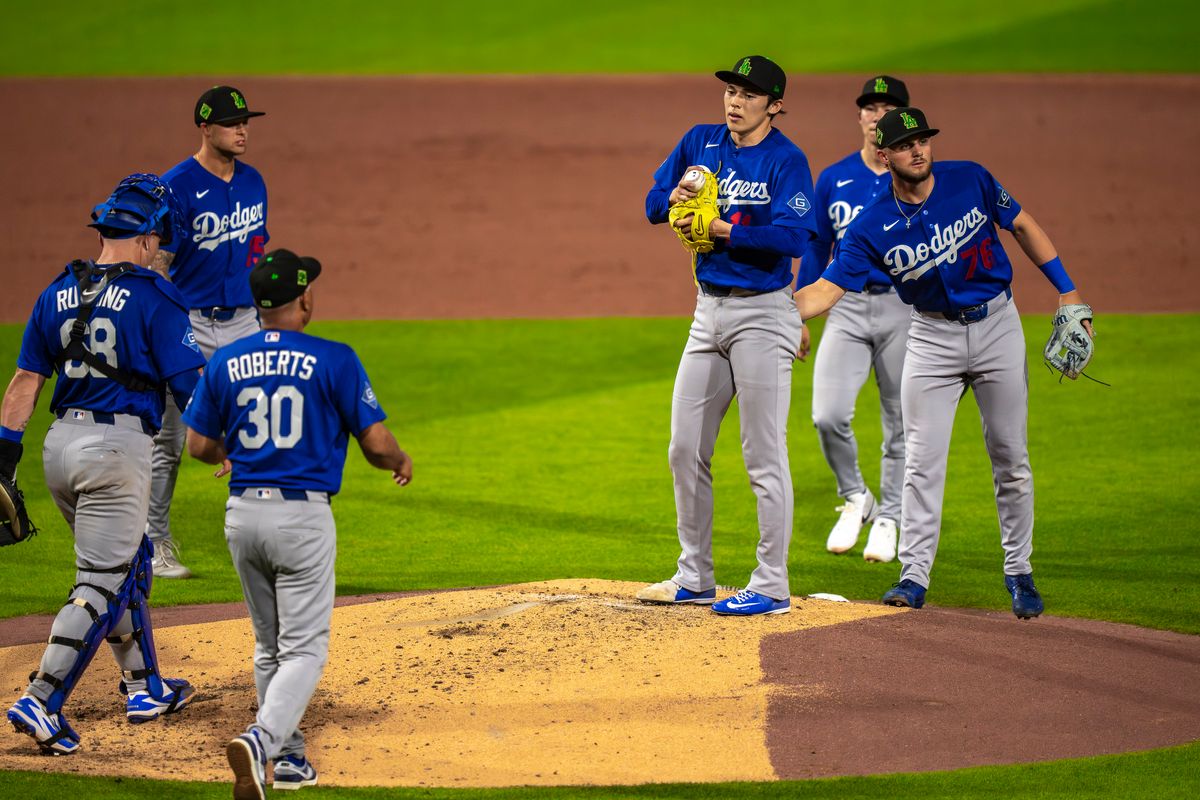 Los Angeles Dodgers pitcher Roki Sasaki (11) being relieved by manager Dave Roberts during an MLB spring training baseball game against the Kansas City Royals on March 17th, 2026 in Surprise, AZ.