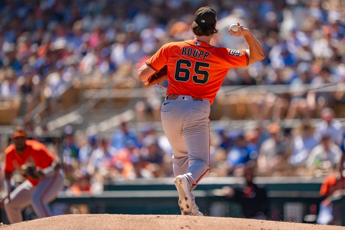 San Francisco Giants pitcher Landen Roupp (65) throwing to first during an MLB spring training baseball game against the Los Angeles Dodgers on March 18th, 2026 in Glendale, AZ.