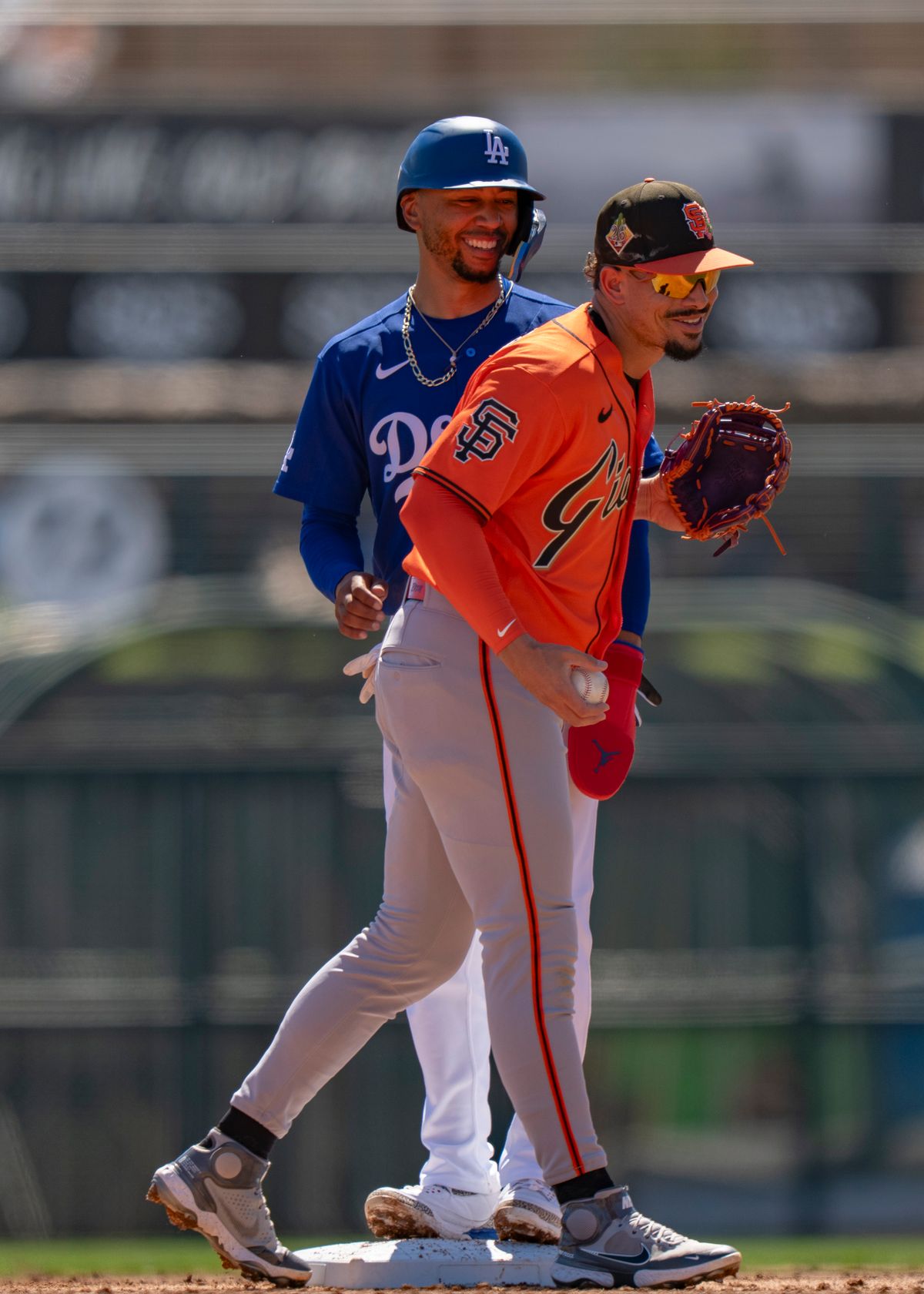 San Francisco Giants shortstop Willy Adames (2) laughing with Mookie Betts during an MLB spring training baseball game against the Los Angeles Dodgers on March 18th, 2026 in Glendale, AZ.