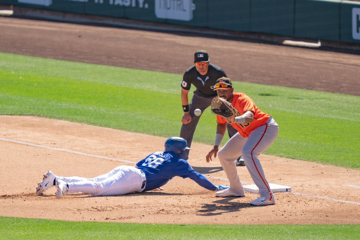 Los Angeles Dodgers catcher Dalton Rushing (68) sliding back to first base, safe, during an MLB spring training baseball game against the San Fransisco Giants on March 18th, 2026 in Glendale, AZ.