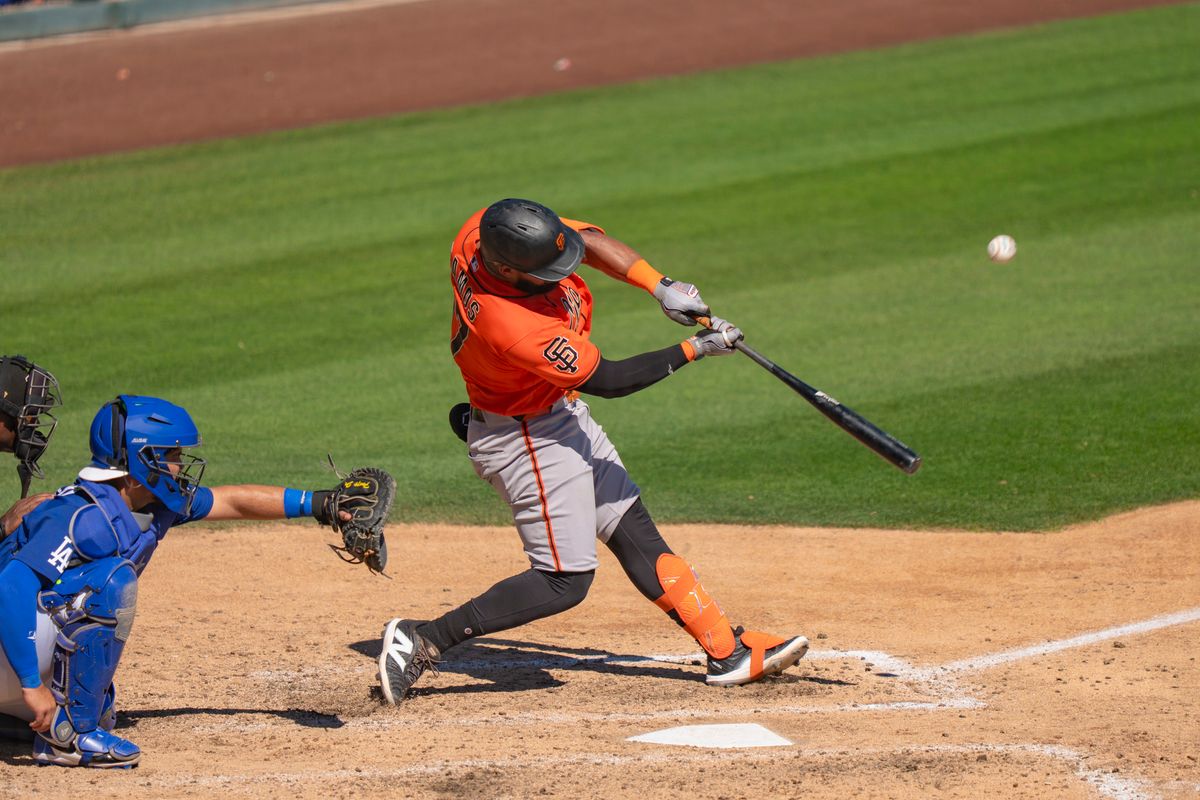 San Francisco Giants outfielder Heliot Ramos (17) hitting a pop fly during an MLB spring training baseball game against the Los Angeles Dodgers on March 18th, 2026 in Glendale, AZ.
