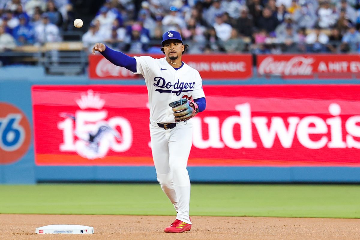 Santiago Espinal #21 of the Los Angeles Dodgers throws to third base during an MLB game against the New York Mets on April 13, 2026 in Los Angeles, CA. Santiago Espinal #21 of the Los Angeles Dodgers throws to third base during an MLB game against the New York Mets on April 13, 2026 in Los Angeles, CA.
