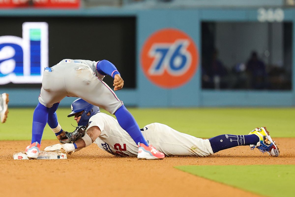 Miguel Rojas #72 of the Los Angeles Dodgers slides to second base during an MLB game against the New York Mets on April 13, 2026 in Los Angeles, CA. Miguel Rojas #72 of the Los Angeles Dodgers slides to second base during an MLB game against the New York Mets on April 13, 2026 in Los Angeles, CA.